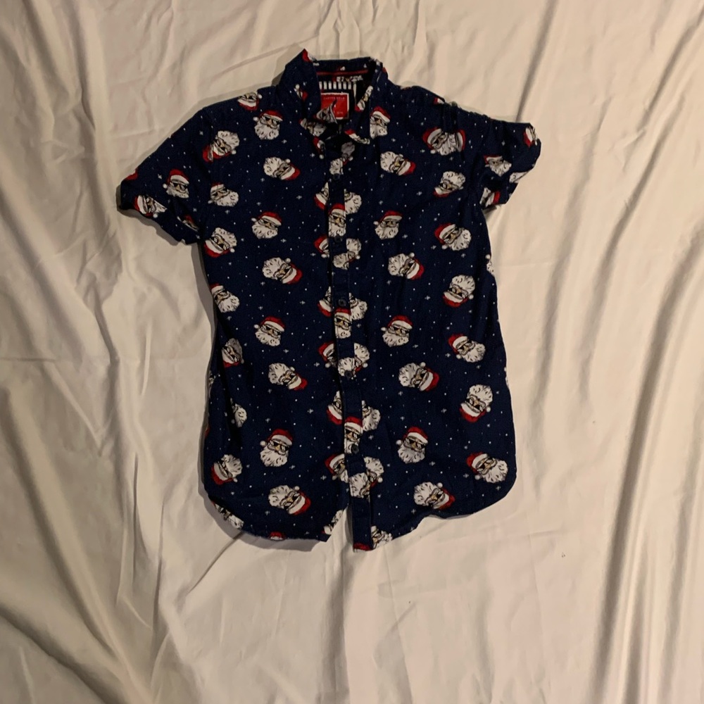 This is a navy blue button down shirt with Santa on it from the cactus boys